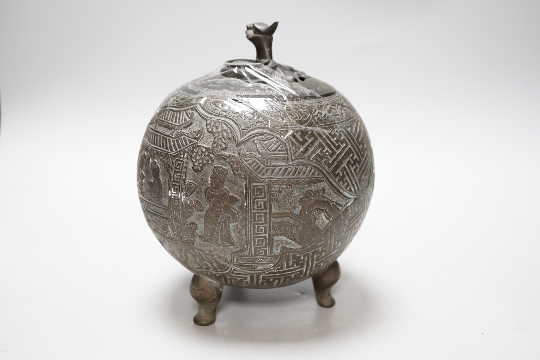 A Chinese three footed cast and chased bronze globular censer and cover, c.1900, 20cm high